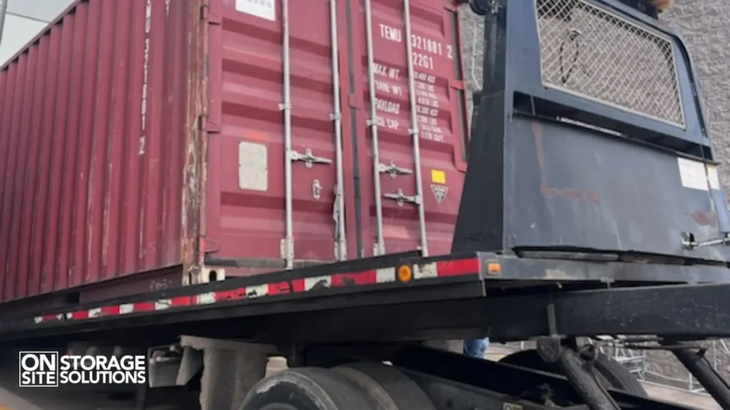 Tilt-bed truck delivering shipping container safely to customer site
