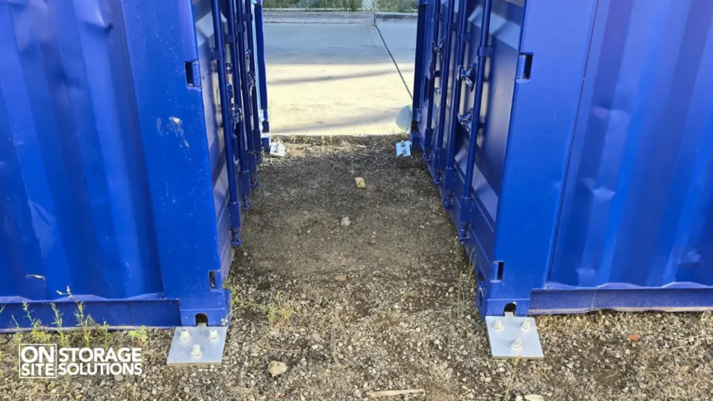 Ground anchors securing a shipping container in soil