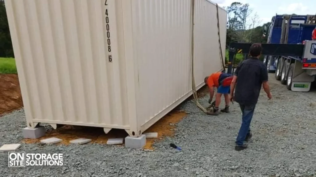 Shipping container anchored to a concrete base plate