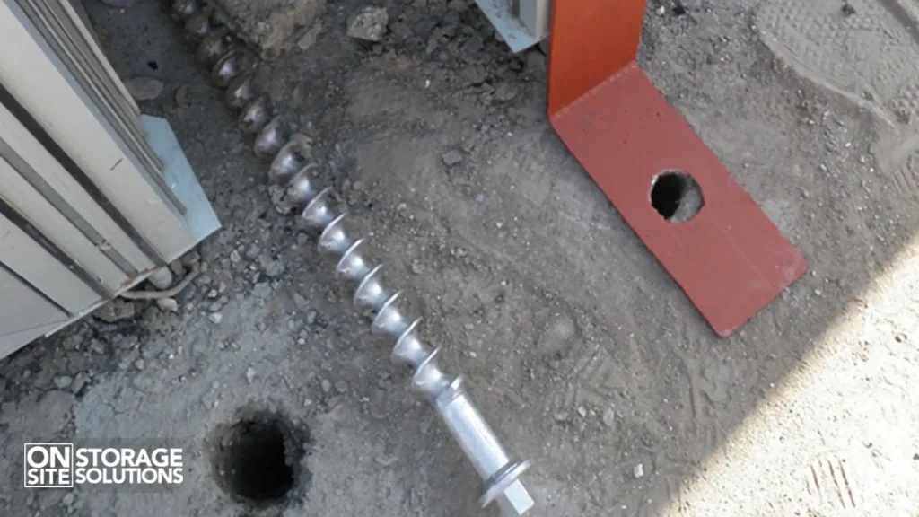 Helical screw anchors being installed for container anchoring